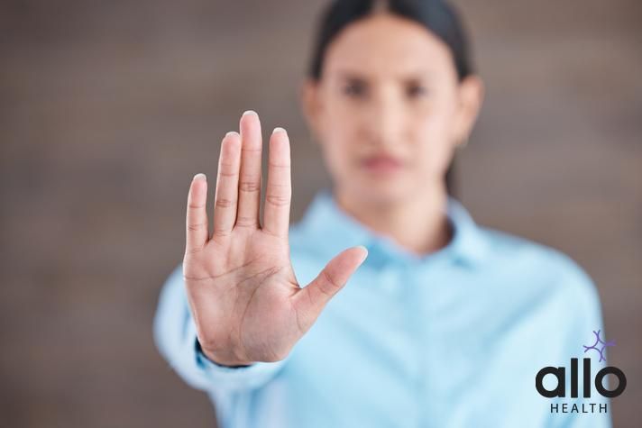 Stop, hand sign and woman with no gesture for sexual harassment and violence in workplace. Business professional, palm and female employee at company with stopping emoji for gender rights at job., Addressing Consent Violations