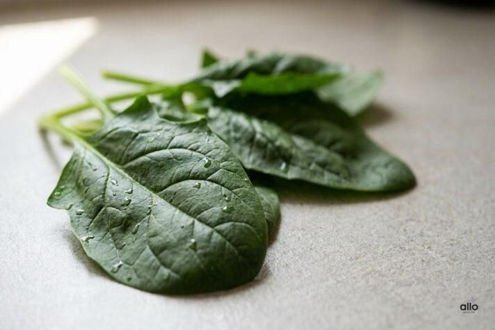Fresh spinach leaves on a kitchen surface, representing nutrient-rich greens that support spinach benefits for erectile dysfunction.