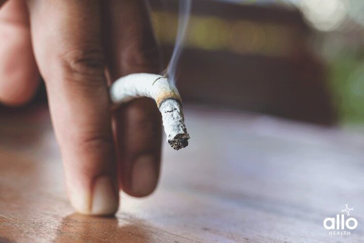 half smoked cigarette and a hand holding it What Are The Causes Of Human Papillomavirus (HPV)?, What Are The Causes Of Bacterial Vaginosis (BV)?
