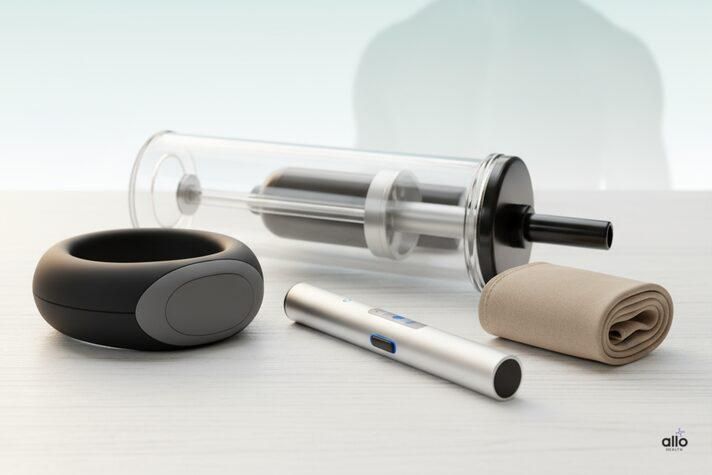 : Different sex toys for erectile dysfunction including pump, ring, and stimulator arranged neatly on a clean surface, representing treatment support options.