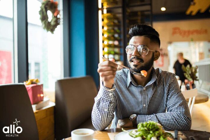 Man sitting and eating food that help in preventing Erectile Dysfunction