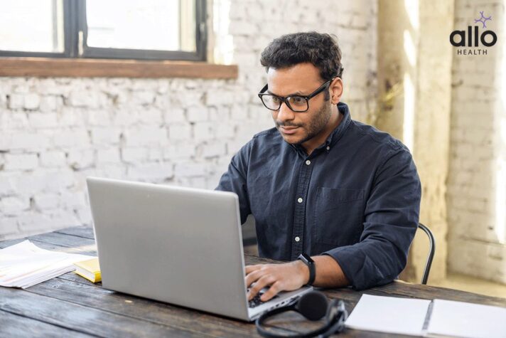 man reading in laptop about the delayed ejaculation